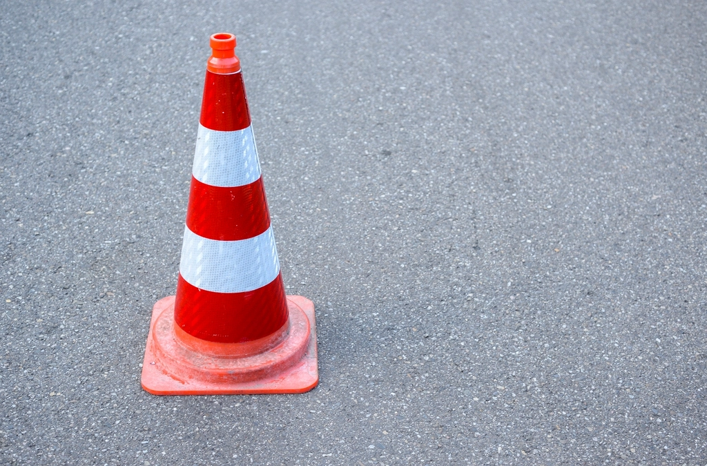 Orange traffic cones lined along a downtown street