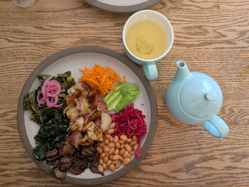 Breakfast plate and teapot on a wooden table