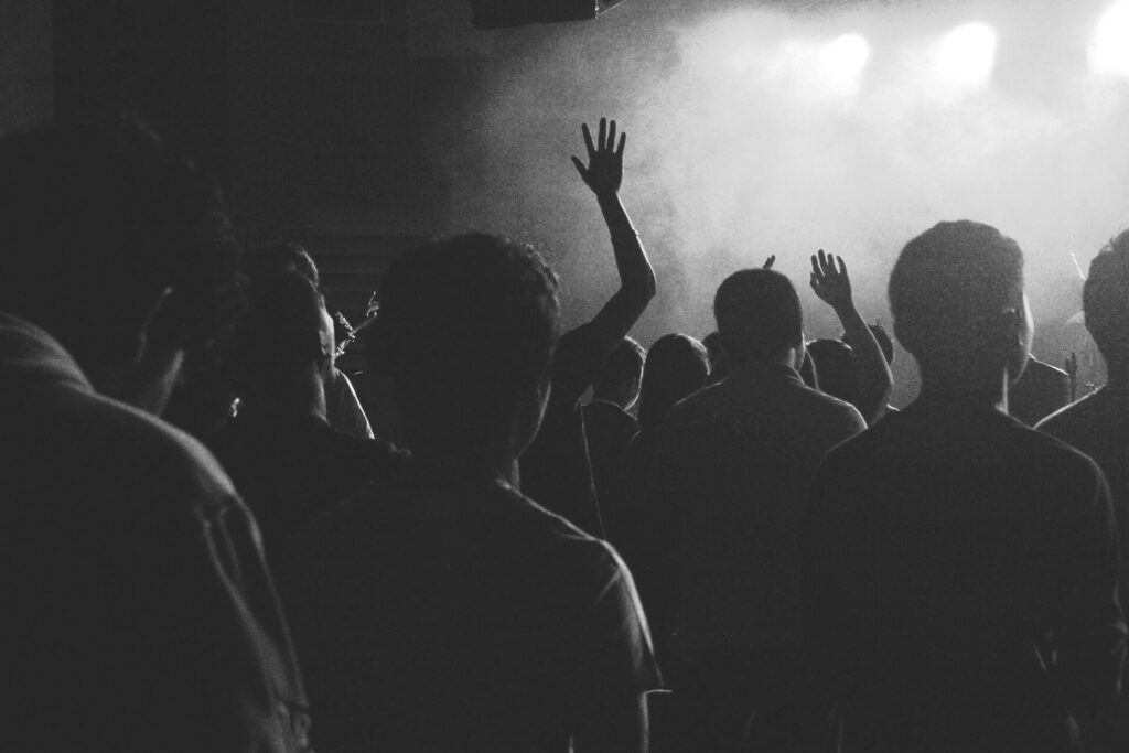 Festival crowd silhouetted against stage lights